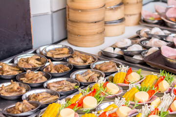 Street Chinese appetizer. Variety of dumplings or dim sum on the small metal plate.