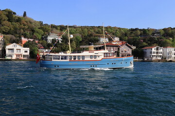 Fototapeta na wymiar Houses and a boat on the Bosphorus of Istanbul.