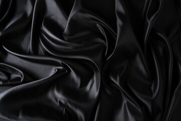 Silk fabric, abstract wavy black satin fabric background.