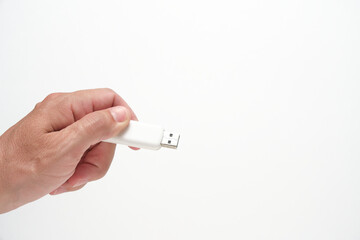 Man hand holds USB flash drive, on white background.