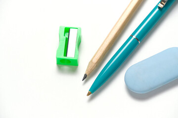Simple pencil, sharpener, ballpoint pen and eraser white background.