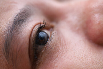 Asian woman eyes with black long eyelashes close up