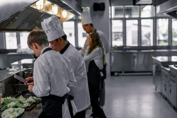 Teenagers learn from expert chefs at culinary school to prepare ingredients and create a variety of...