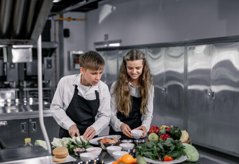 Teenagers learn from expert chefs at culinary school to prepare ingredients and create a variety of tasty meals. A practical activity connected their senses of taste and smell is making hamburgers.