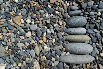 Zen tower on a stony beach. The tower is made of various pebbles.