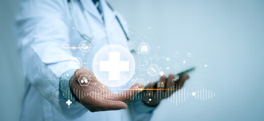 A medical worker holding medical cross shape digital healthcare network connection with analysis...