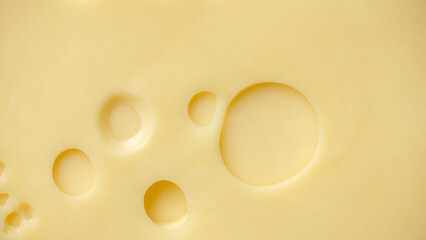 Slice Of Cheddar Cheese Gouda Cheese with holes top view