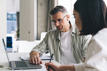 Focused colleagues working on project in office