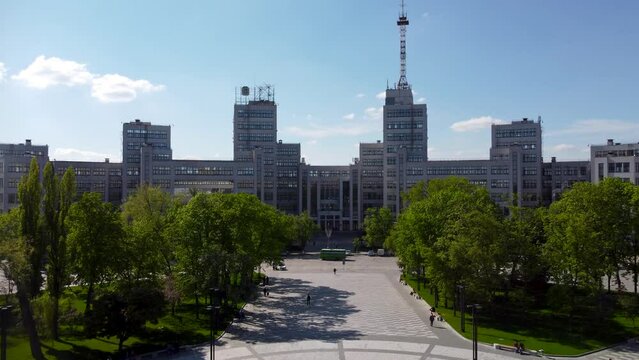 Aerial dolly footage Derzhprom building with blue sky in spring Kharkiv city center, Ukraine. Constructivist architecture style