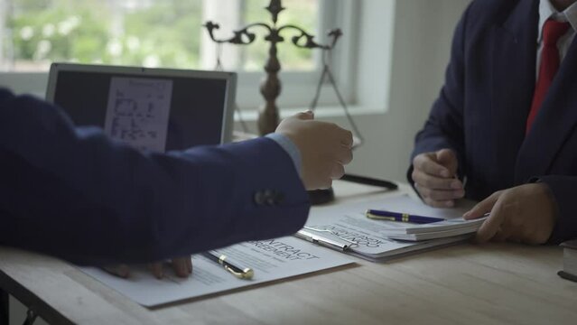 Businessman trying to bribe legal officials and lawyers Corruption and Bribery Businessman files a legal complaint against Lawyer receives money from businessman and shakes hands