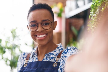 African american woman florist smiling confident make selfie by camera at florist