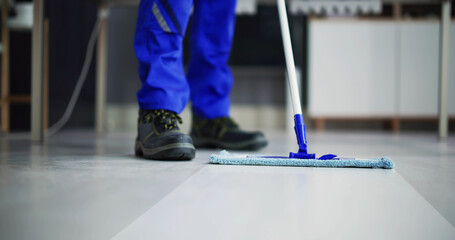 Portrait Of Happy Male Janitor Cleaning Floor