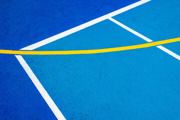 Sport field court background. Blue rubberized and granulated ground surface with white, yellow...