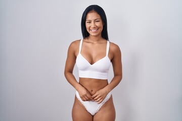 Hispanic woman wearing lingerie with a happy and cool smile on face. lucky person. - obrazy, fototapety, plakaty