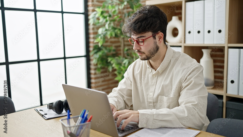 Sticker young hispanic man business worker using laptop working at office