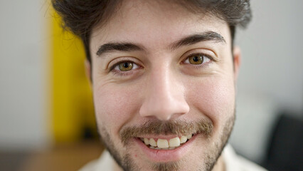 Obraz premium Young hispanic man smiling confident sitting on sofa at home