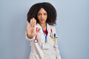 Young african american woman wearing doctor uniform and stethoscope doing stop sing with palm of...