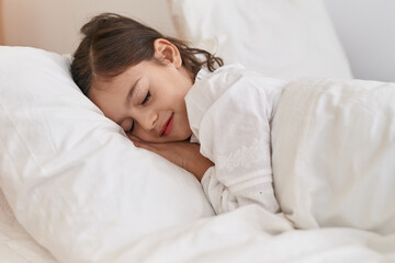 Adorable hispanic girl lying on bed sleeping at bedroom