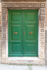 old green door with decorations in the door frame