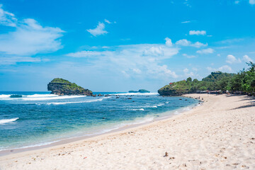 Beautiful Watukarung Beach in Pacitan, Indonesia with rocks on the ocean.