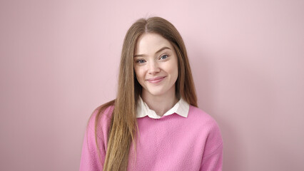 Fototapeta premium Young blonde woman smiling confident standing over isolated pink background