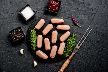raw sausages on a stone background