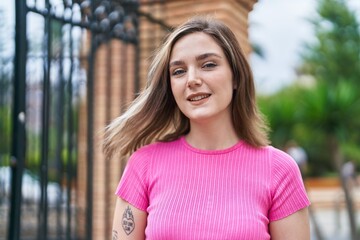 Young woman smiling confident standing at street