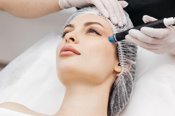 Perfect cleansing. Face of a beautiful pleasant woman being cleansed during hydrafacial procedure
