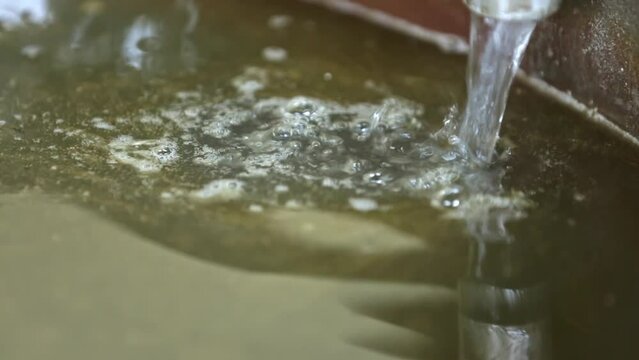 Adding lye solution to natural organic oils in saponification soap making