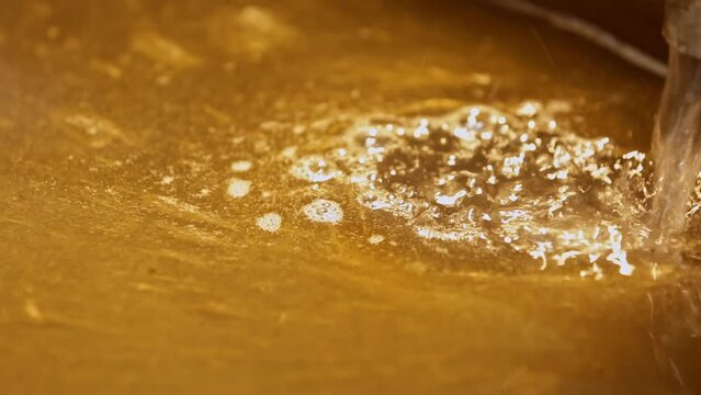 Adding lye solution to natural organic oils in saponification soap making