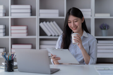 Young happy businesswoman working with tablet in office.