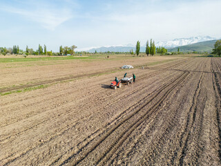 Aerial view of tractor plowing the field