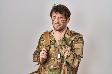 Hispanic young man wearing camouflage army uniform touching painful neck, sore throat for flu, clod and infection