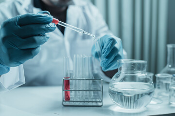Scientist holding flask with lab glassware and chemistry laboratory test tubes Research and development in science laboratory, science technology concept
