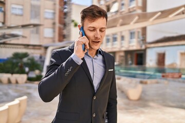 Young man business worker smiling confident talking on smartphone at park