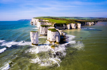 Aerial panoramic view of limestone cliffs and stacks with countryside at Old Harry Rocks in Dorset,...