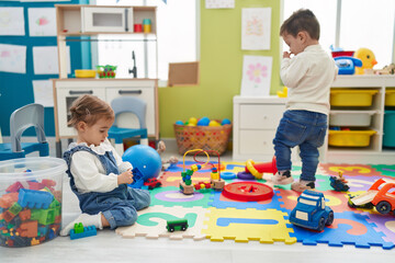 Adorable boy and girl playing at kindergarten