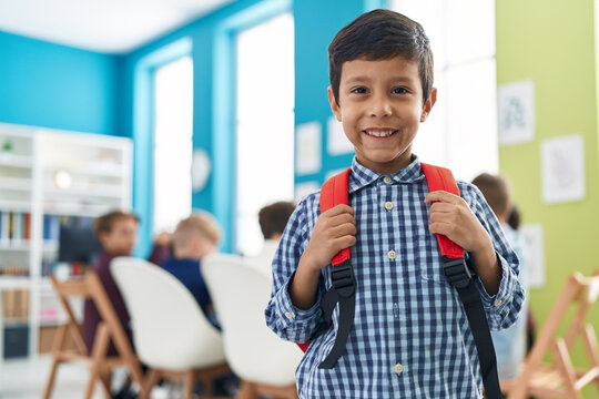 Adorable hispanic boy student smiling confident standing at classroom