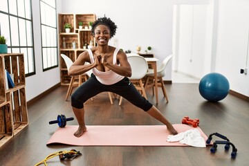 African american woman smiling confident training yoga at home