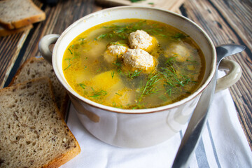 Soup close-up. Soup with meatballs. On a wooden background.