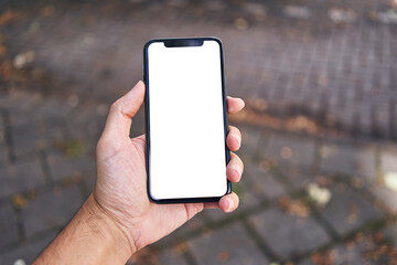 Man holding smartphone showing white blank screen at street