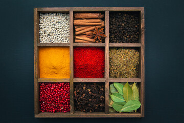 Spices and seasonings for cooking in a wooden box.