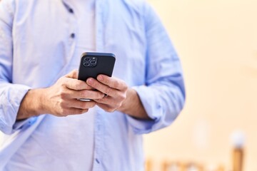 Young caucasian man using smartphone at street