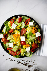 A green vegan salad made from a mix of green leaves and vegetables. white background