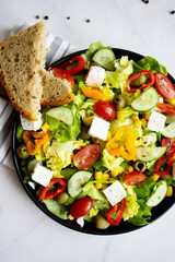 A green vegan salad made from a mix of green leaves and vegetables. white background