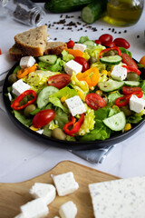 A green vegan salad made from a mix of green leaves and vegetables. white background