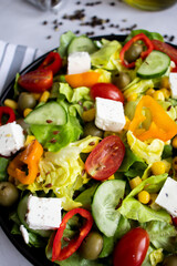 A green vegan salad made from a mix of green leaves and vegetables. white background