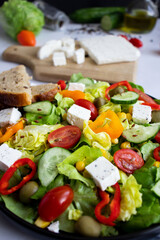 A green vegan salad made from a mix of green leaves and vegetables. white background