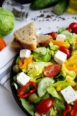 A green vegan salad made from a mix of green leaves and vegetables. white background