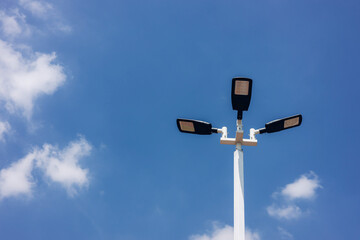 A modern street LED lighting pole. Urban electro-energy technologies. Poles on the road with LED light. Outdoor lighting strong LED lamp.